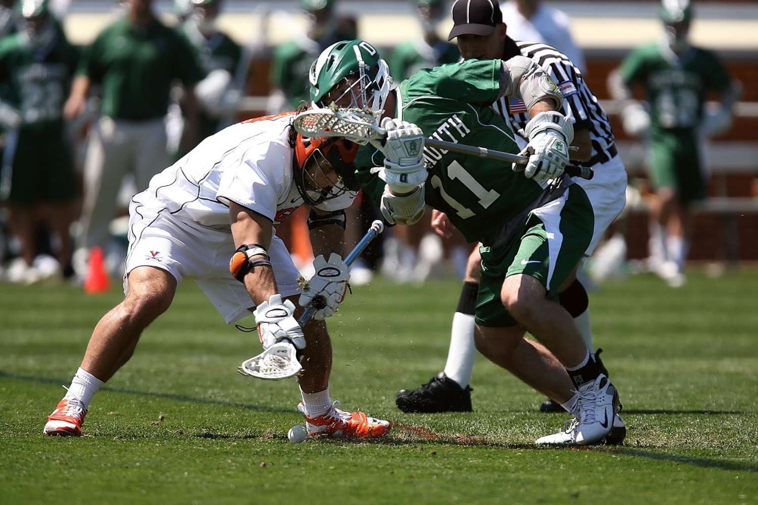 Lacrosse players chasing the ball