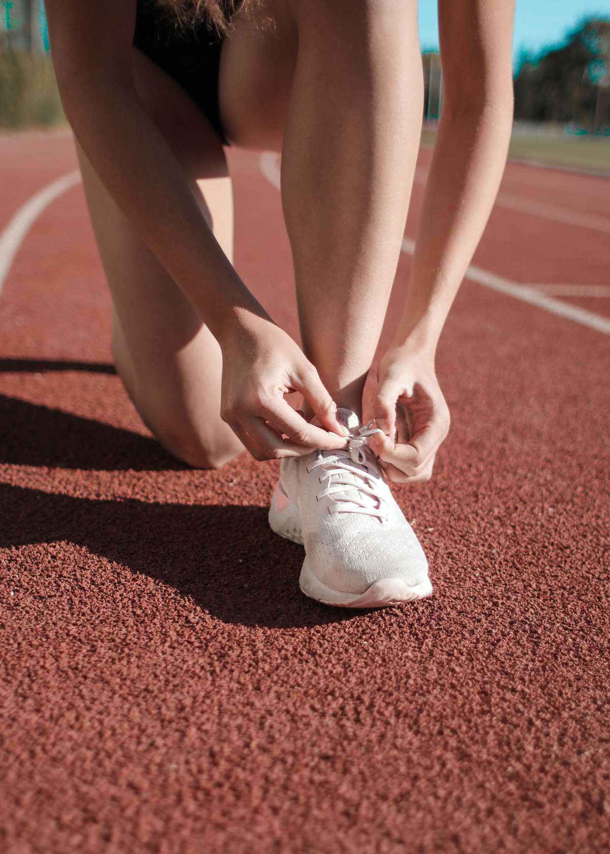 A runner ties running shoes